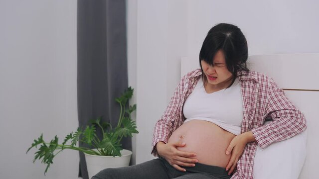 pregnant woman is experiencing severe pain as a result of the normal. Symptoms of abdominal and back pain begin to appear more with the increasing gestational age. concept pain during pregnancy.