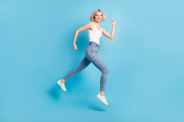 Fototapeta na wymiar Full size profile side photo of cheerful happy young woman run empty space jump up isolated on blue color background
