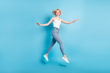 Fototapeta na wymiar Full body profile side photo of happy young cheerful lady jump up go empty space isolated on blue color background