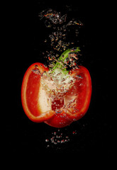 Red pepper slice splashing in water