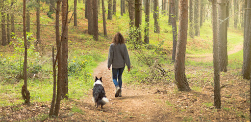 calm woman walking alone in the forest in search of adventure