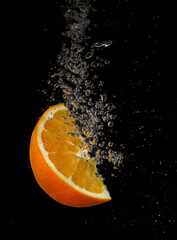 Fototapeta na wymiar Orange slice splashing in water