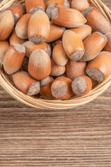 hazelnuts with nutshells in the basket on a wooden table