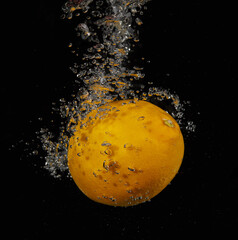 Lemon falling in water