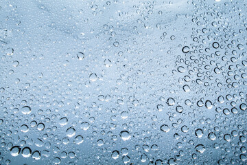 Water droplets and raindrops on clear glass