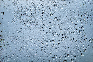 Water droplets and raindrops on clear glass