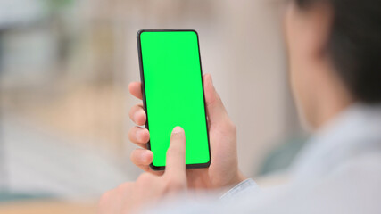 Rear View, Man using Smartphone with Green Chroma Key Screen