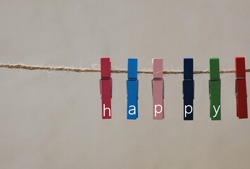 the happy concept hanging on peg on a clothesline