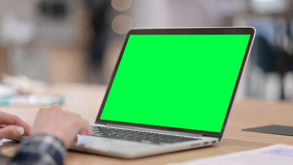 Fototapeta na wymiar Female Hands Typing on Laptop with Green Chroma Key Screen