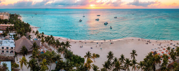 Beach in the Caribbean ocean with people and boats