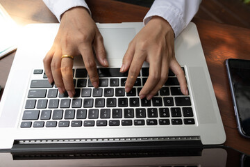 Fototapeta na wymiar Top view,woman using laptop, searching web, browsing information, having workplace at home