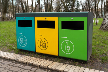 waste sorting containers. separate waste bins for glass, plastic and paper. Waste sorting, three...