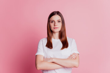 Fototapeta premium Beautiful focused attractive girl folded hands isolated over pink background