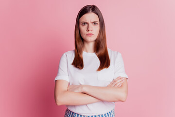 Beautiful upset girl frowning offended face isolated over pink background