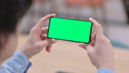 Man Watching Smartphone with Green Chroma Key Screen Close up