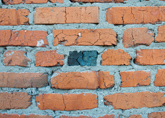 Old weathered red brick wall for texture or background, classic rough aged brickwork, vintage masonry with cement mortar