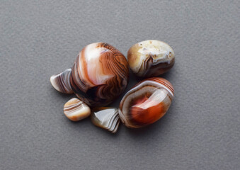 Multicolored gemstones, tumbled minerals. Agates of various sizes. Bostwan agate