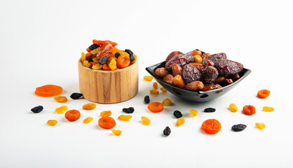 Mix of dried fruits in a plate on a white background.	
