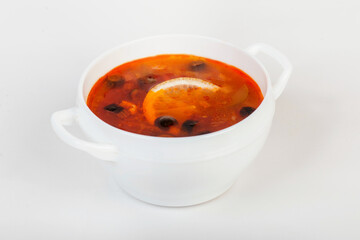 Solyanka soup isolated on a white background. Russian and Ukrainian cuisine.