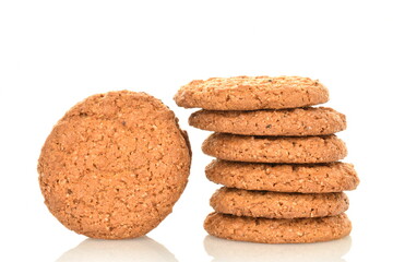 Several fragrant dark brown oatmeal cookies, close-up, isolated on white.
