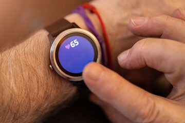 Fototapeta premium Elderly man hand and detail of the smartwatch 