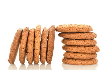 Several fragrant dark brown oatmeal cookies, close-up, isolated on white.