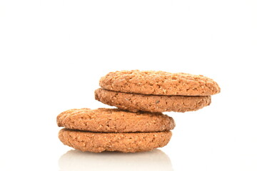Several fragrant dark brown oatmeal cookies, close-up, isolated on white.