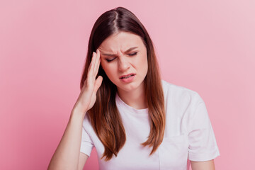 Troubled young woman have terrible headache over pink background