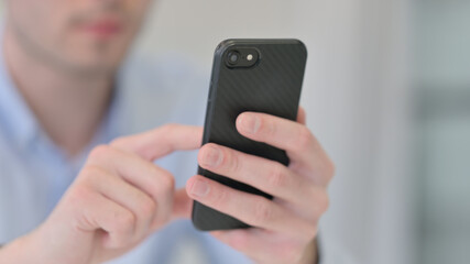 Close up of Young Man using Smartphone