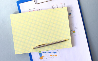 Notepad with blank space for text on a folder with diagrams.