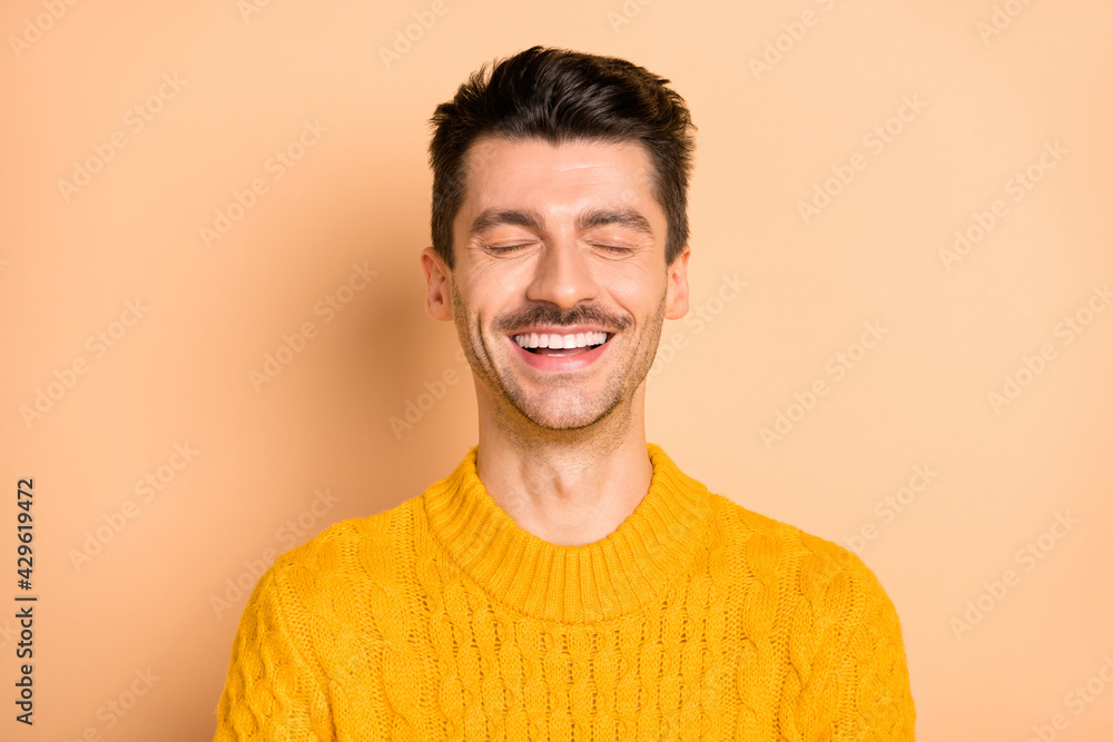 Sticker Photo portrait of overjoyed laughing man dreamy with closed eyes isolated on pastel beige color background