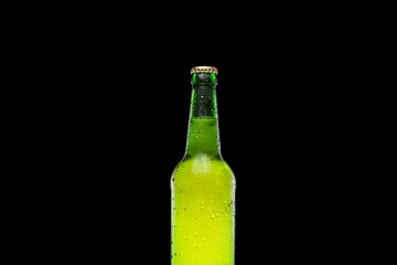 Fresh and cold green beer bottle on black background