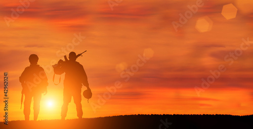 Military man and military woman on sunset background is symbol of equal rights.