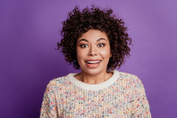 Surprised happy young woman face in excitement look camera on purple wall