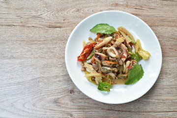 spicy stir fried squid with mussel and mashed pork couple bamboo shooting  basil leaf on plate