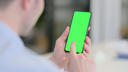 Young Man Using Smartphone with Green Screen 