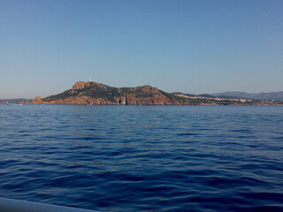 Fototapeta premium Scenic panoramic landscape of the town of the sea country in the morning. Beautiful view of the sea and mountains. Seascape with coast of island. Skyline view from yacht in the sea.