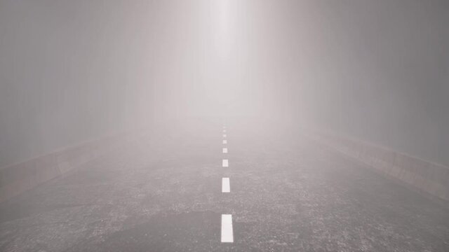 Traveling slowly down an empty highway on a dark foggy night.