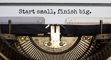 Start small finish big symbol. Concept words 'Start small finish big' typed on retro typewriter. Business, motivational and start small finish big concept.