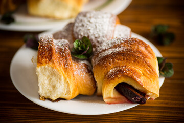 baked sweet homemade buns with plum inside