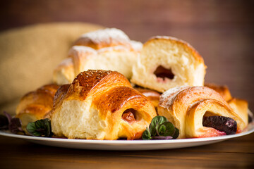 baked sweet homemade buns with plum inside