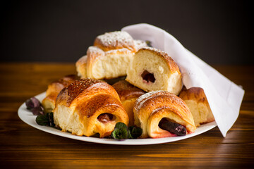 baked sweet homemade buns with plum inside