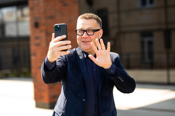 Handsome Boss making video call in Street