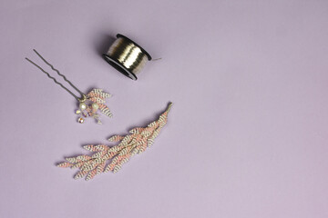 Handmade hair accessories and wire on violet background