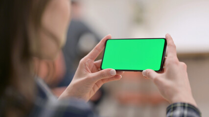 Female Watching Smartphone with Green Chroma Key Screen