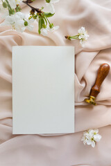 Mockup invitation, blank paper greeting card, floral background, flat lay