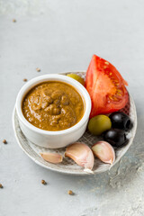 raw vegetarian delicious sauce made from tomatoes, olivies and garlic, health content, vertical format