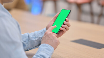 Man using Smartphone with Green Chroma Key Screen