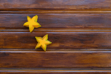 Two yellow stars on the wooden table, empty, copy for space text