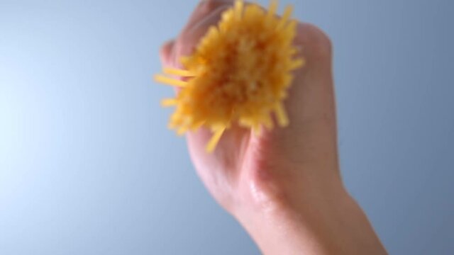 Throwing spaghetti pasta into water. Overhead shot. slow motion. selective focus